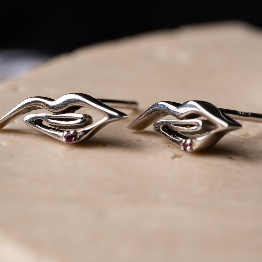Silver lip-shaped mini stud earrings with red zircon stone, sculptural design by AGUDO Studio